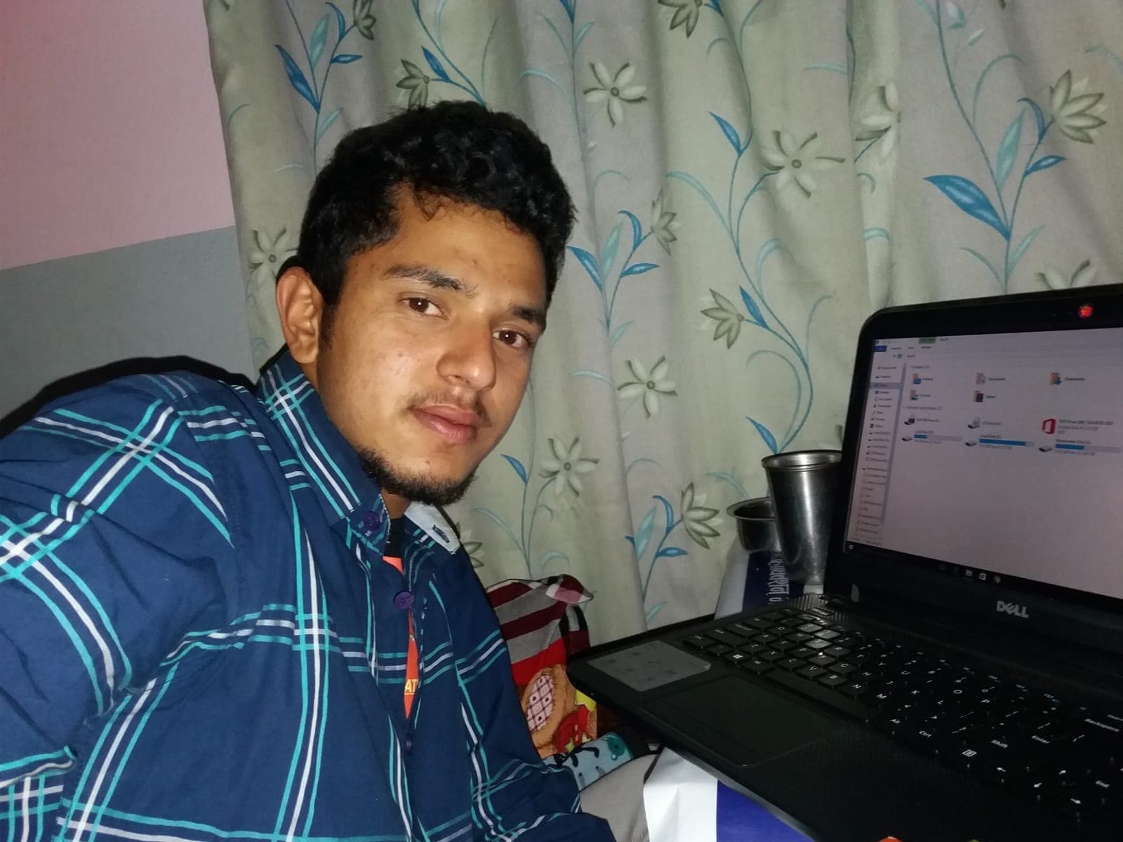 Young Rabin Paudel working on a Dell laptop at home